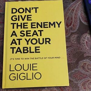Don't Give The Enemy A Seat At Your Table by Louie Giglio - Yellow hardback book